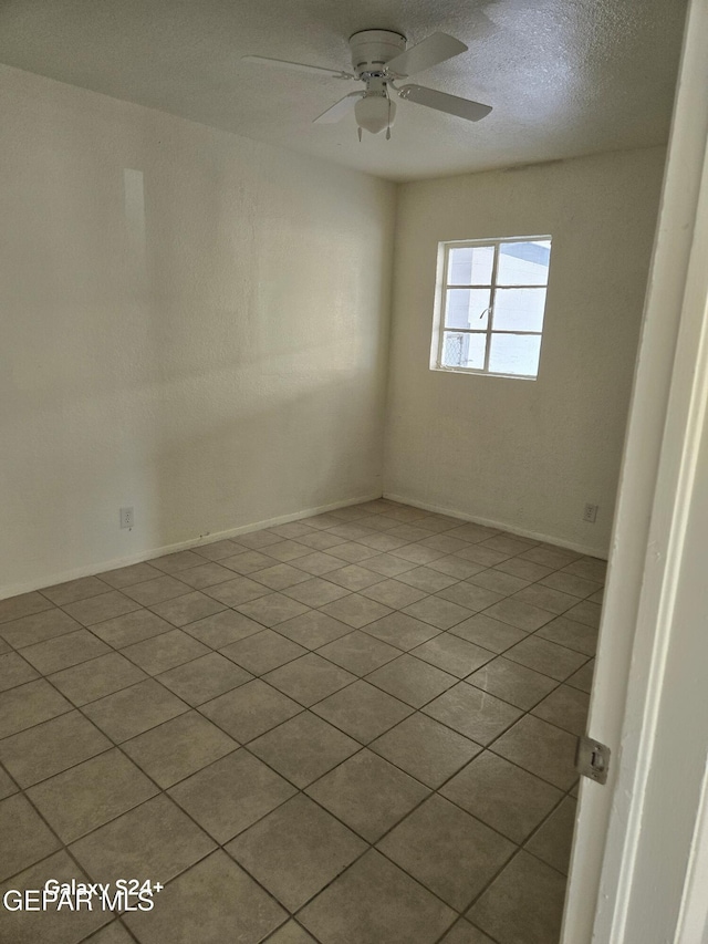 spare room featuring a textured ceiling and ceiling fan