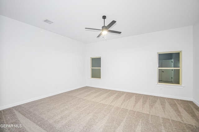 carpeted empty room featuring ceiling fan