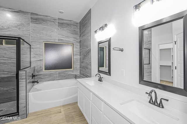 bathroom with vanity, plus walk in shower, and hardwood / wood-style floors