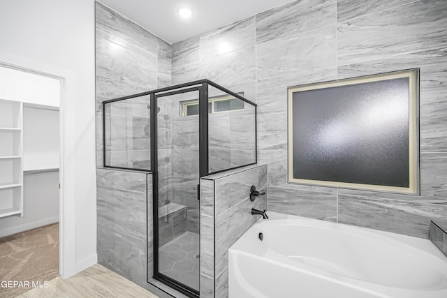 bathroom with separate shower and tub