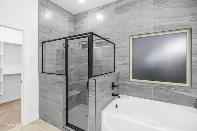 bathroom with shower with separate bathtub