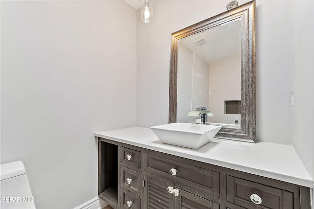 bathroom featuring vanity and toilet