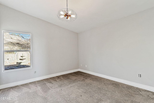 unfurnished room with an inviting chandelier and carpet