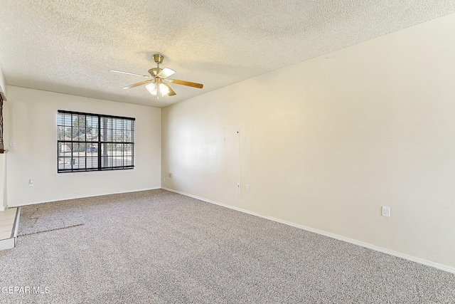 empty room featuring ceiling fan, carpet flooring, and a textured ceiling