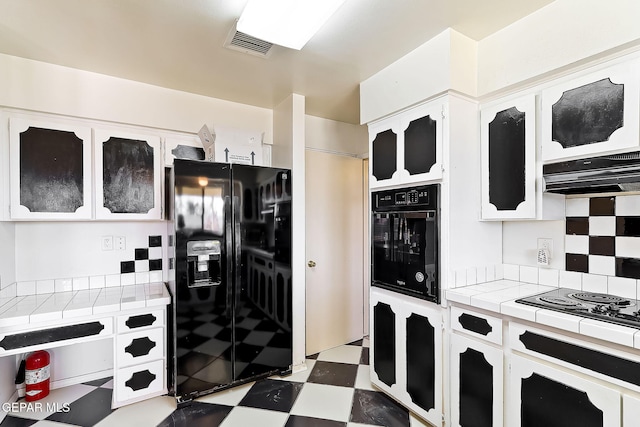 kitchen with backsplash, white cabinets, tile counters, and black appliances