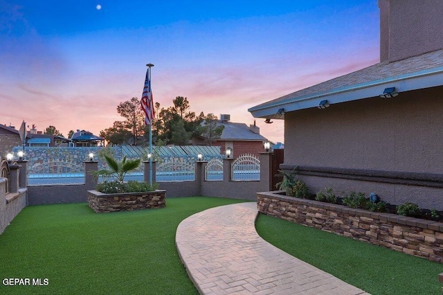 yard at dusk featuring a patio area