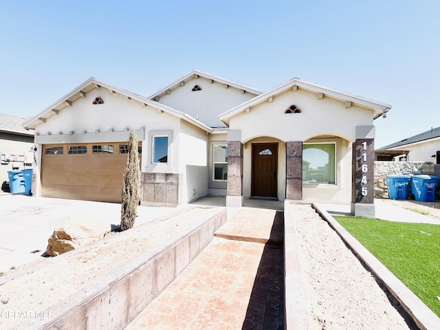 mediterranean / spanish-style house featuring stucco siding and a garage