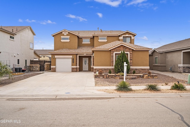 view of front of home with central air condition unit and a garage