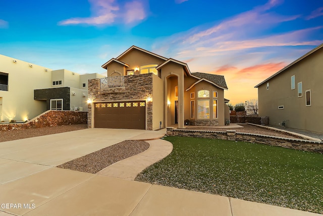 view of front of house with a garage, a balcony, and a yard