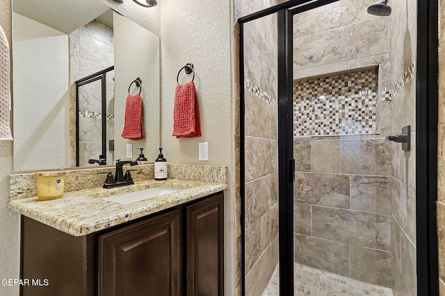 bathroom with vanity and a shower with shower door