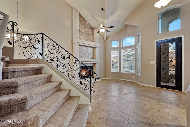 foyer entrance with high vaulted ceiling and ceiling fan