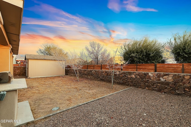 yard at dusk with a storage shed