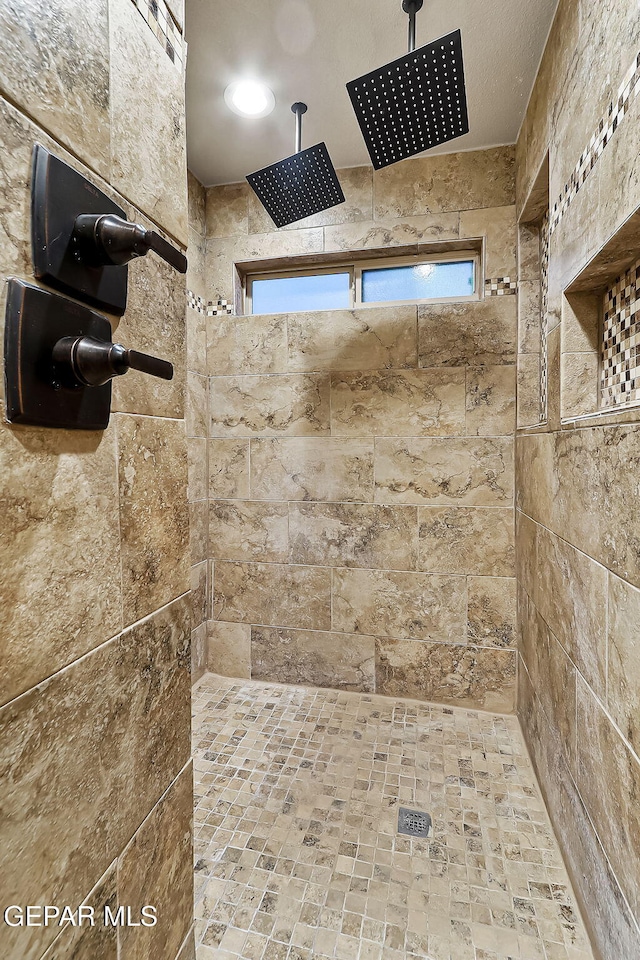 bathroom with tiled shower