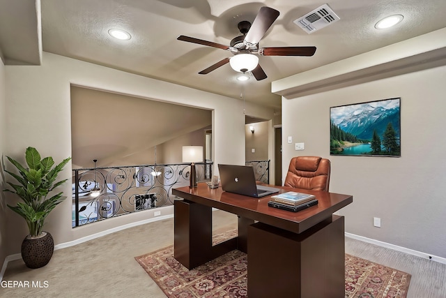 office with ceiling fan and a textured ceiling