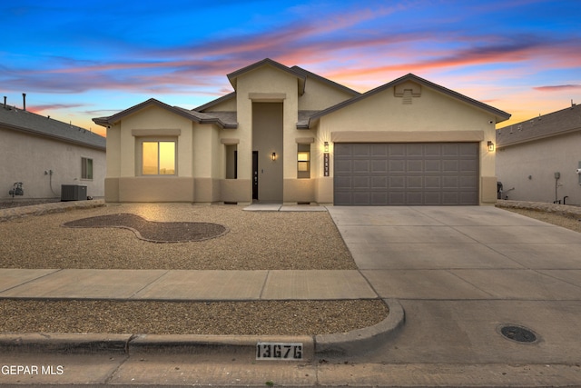 view of front of home with central AC and a garage