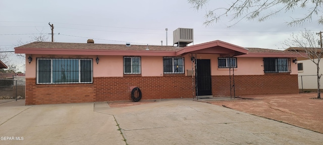 back of house with central AC unit