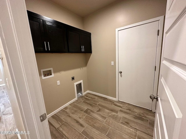 clothes washing area featuring cabinets, washer hookup, and hookup for an electric dryer