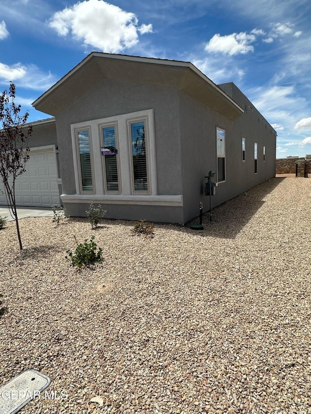 view of side of home with a garage