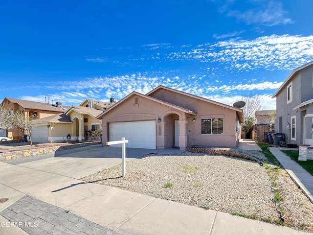 single story home with driveway, an attached garage, and stucco siding