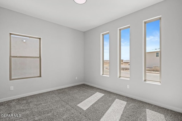 carpeted empty room featuring plenty of natural light