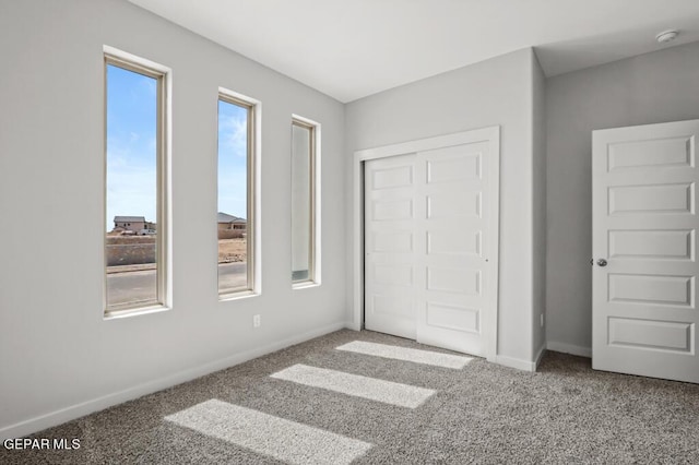 unfurnished bedroom with a closet and carpet