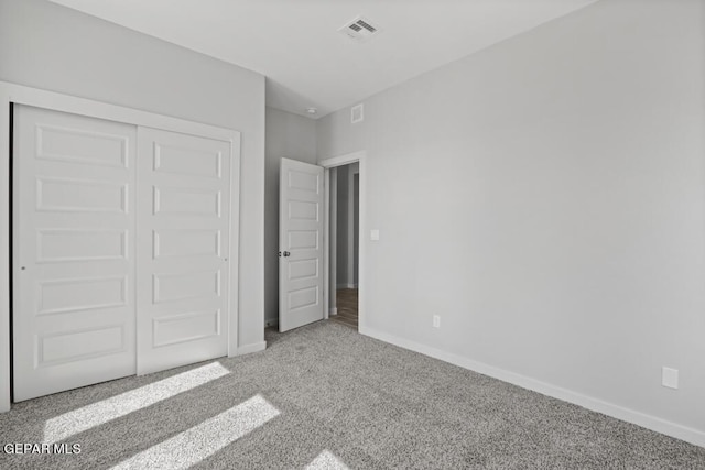 unfurnished bedroom featuring a closet and carpet