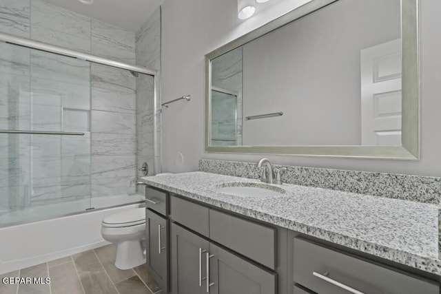 full bathroom with vanity, toilet, and combined bath / shower with glass door