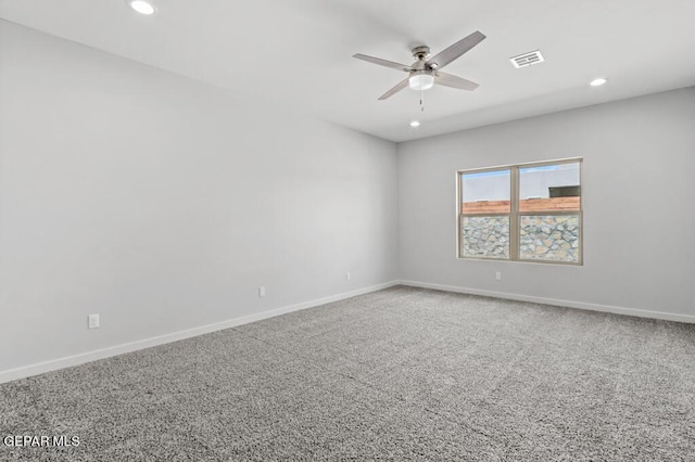 carpeted spare room with ceiling fan