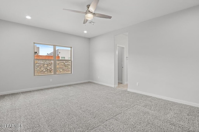 empty room with light colored carpet and ceiling fan