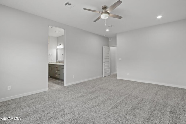 carpeted spare room with ceiling fan