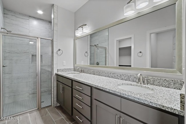 bathroom featuring vanity and an enclosed shower