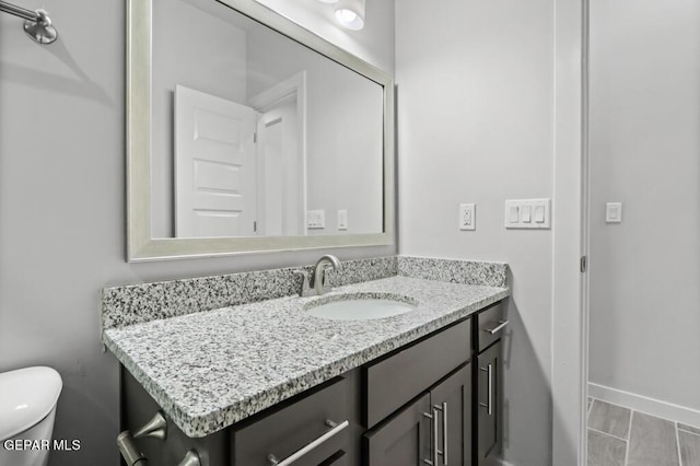 bathroom featuring vanity and toilet