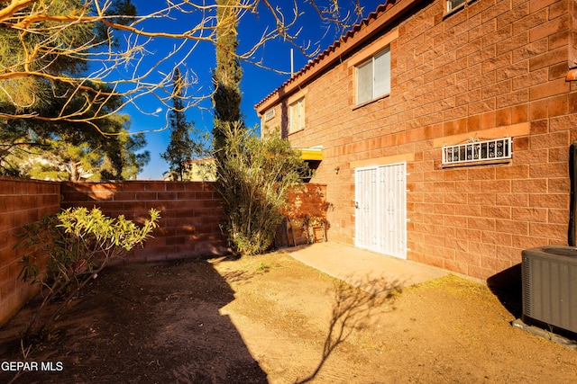 exterior space with a patio and cooling unit