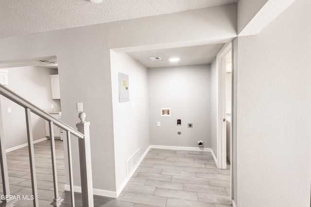 clothes washing area featuring washer hookup, hookup for an electric dryer, and a textured ceiling