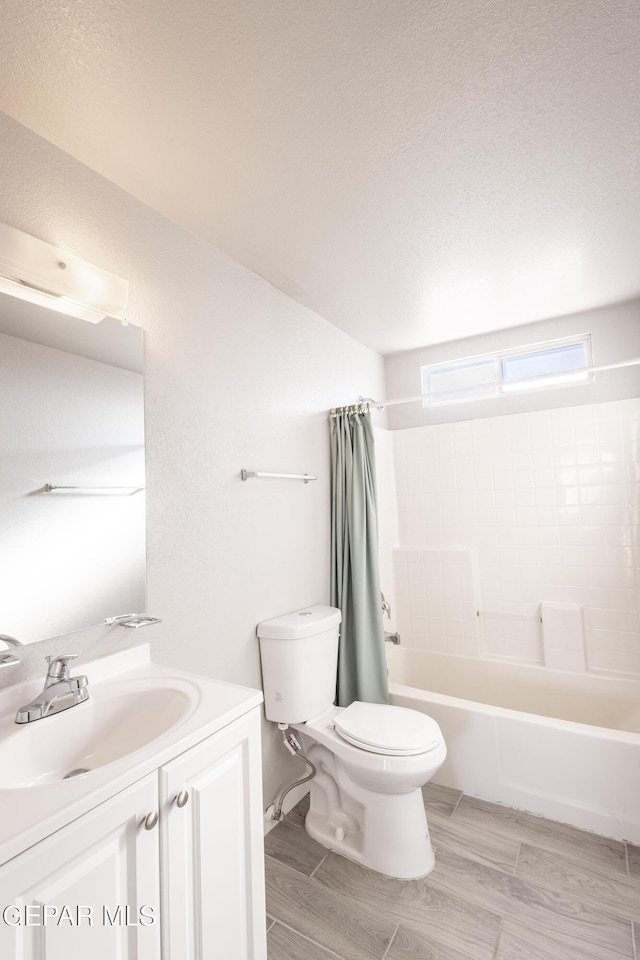 full bathroom with a textured ceiling, toilet, vanity, and shower / bathtub combination with curtain