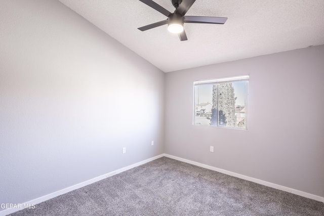 unfurnished room featuring carpet, vaulted ceiling, a textured ceiling, and ceiling fan