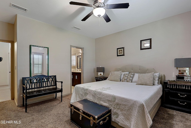 bedroom with connected bathroom, ceiling fan, and carpet