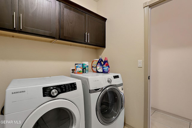 laundry room with cabinets and washing machine and clothes dryer