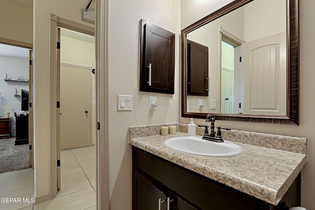 bathroom with tile patterned floors and vanity