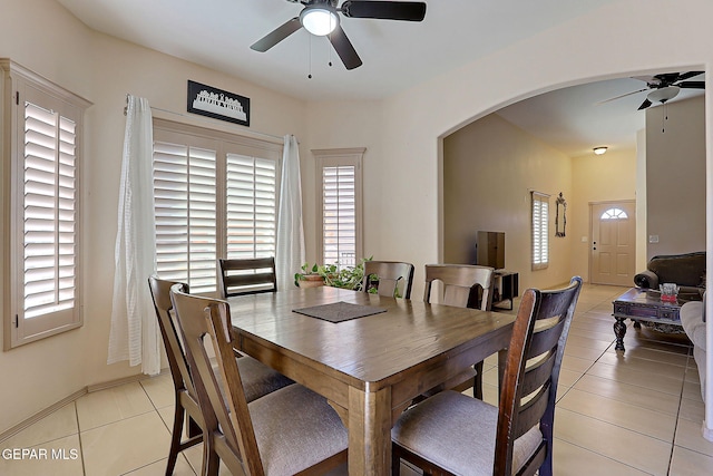 tiled dining space featuring a wealth of natural light and ceiling fan