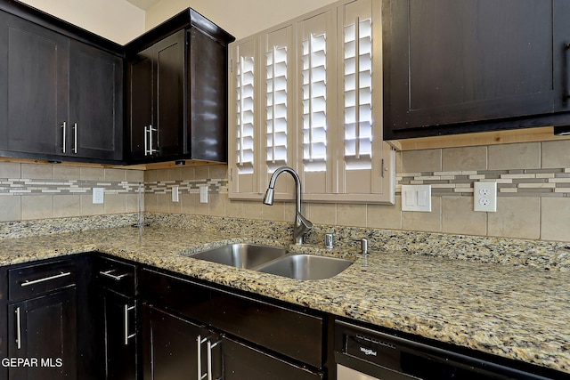 kitchen with tasteful backsplash, dark brown cabinets, sink, and dishwashing machine