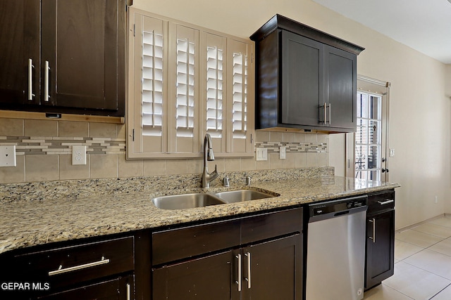 kitchen with light stone counters, sink, backsplash, and dishwasher