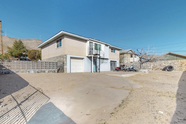 view of side of property with a garage and a mountain view