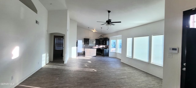 kitchen featuring a kitchen island, dark hardwood / wood-style flooring, high vaulted ceiling, and ceiling fan