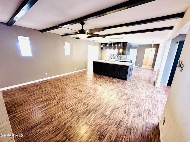 kitchen featuring decorative light fixtures, beamed ceiling, light hardwood / wood-style floors, and ceiling fan