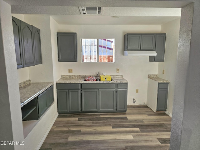 kitchen with gray cabinets, sink, and dark hardwood / wood-style floors