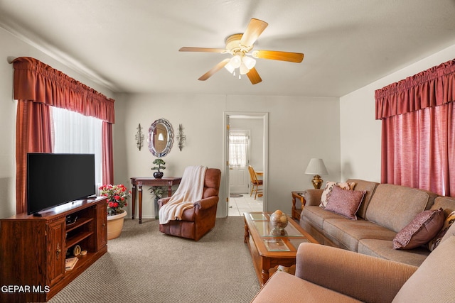 carpeted living room featuring ceiling fan