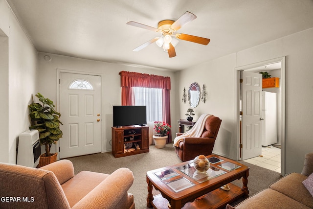 carpeted living room with ceiling fan and heating unit