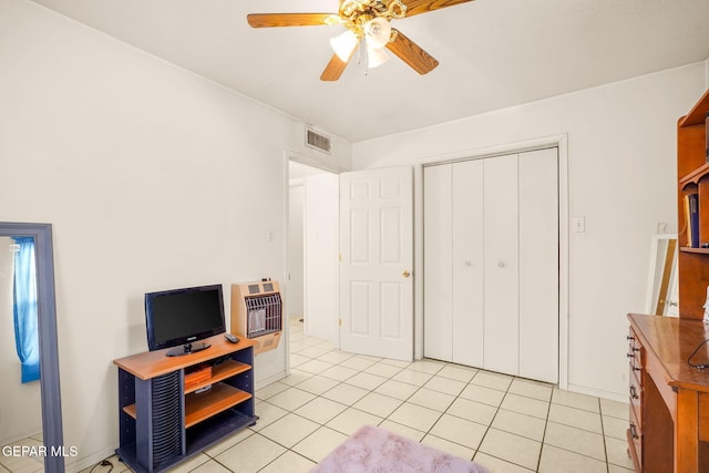 office with heating unit, ceiling fan, and light tile patterned floors