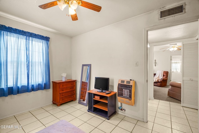 tiled home office with heating unit and ceiling fan